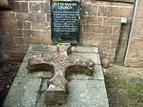 This Cross, which formerly adorned the north gable of the Barony Church in Commercial Street, is placed here as a symbol of the healing of the schisms caused by the Secession in 1781 and the Disruption of 1843, through the re-union of the congregations in Alyth Parish Church in 1977.