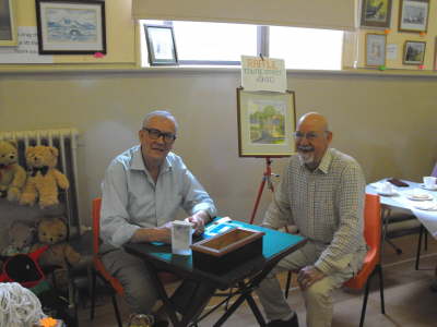 Stanley Sim sells Ian Anderson a raffle ticket for the beautiful painting of Alyth's Toutie Street by Mrs Sheila Brough